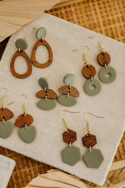 triangular polymer clay earrings in eucalyptus green with rectangular wooden pendant