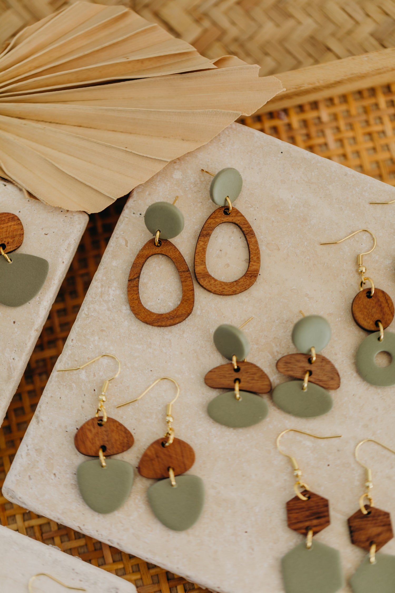 triangular polymer clay earrings in eucalyptus green with rectangular wooden pendant