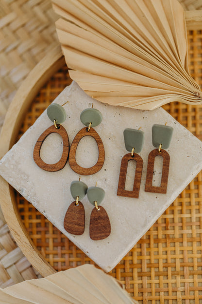 triangular polymer clay earrings in eucalyptus green with rectangular wooden pendant