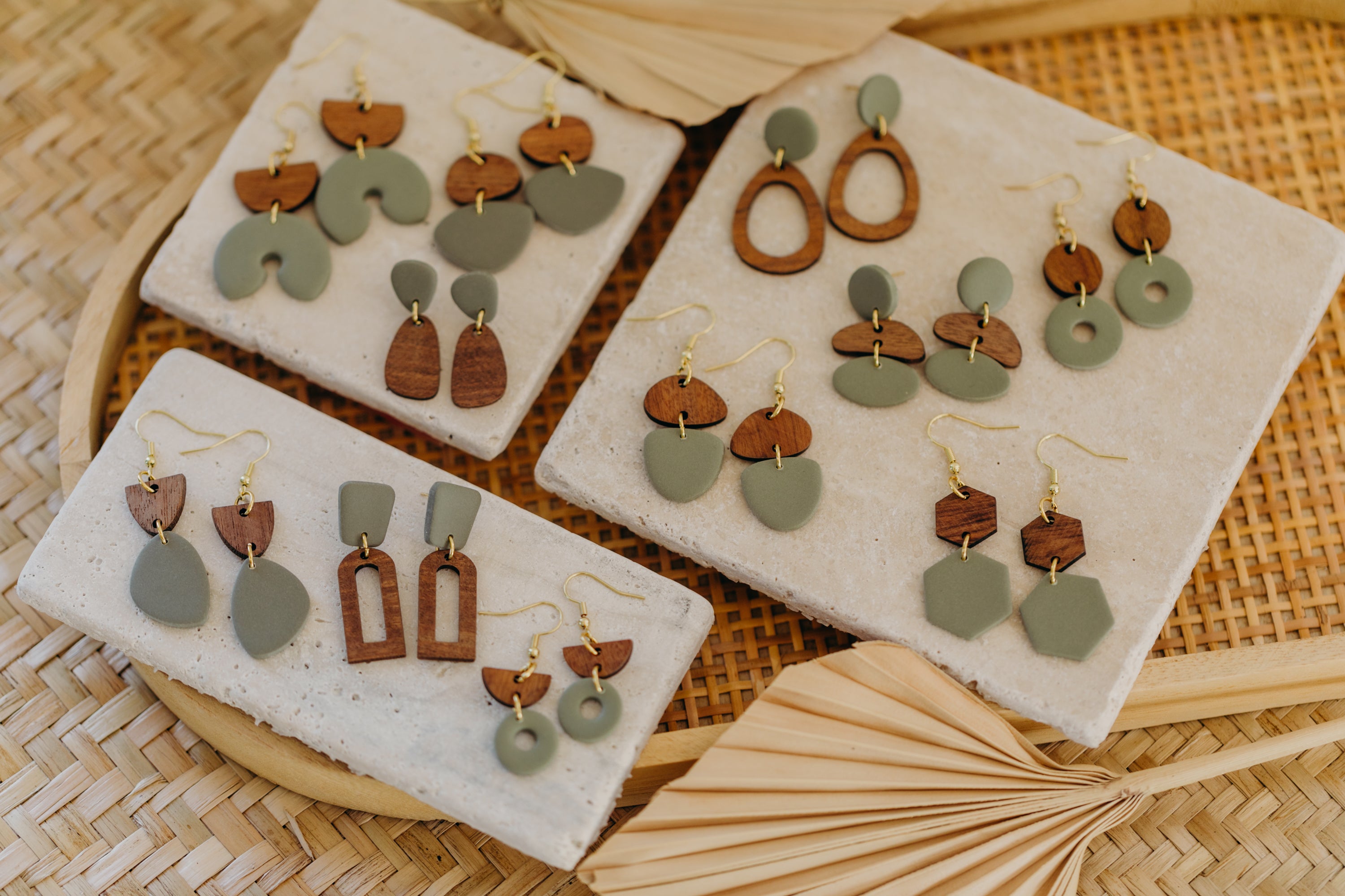 triangular polymer clay earrings in eucalyptus green with rectangular wooden pendant