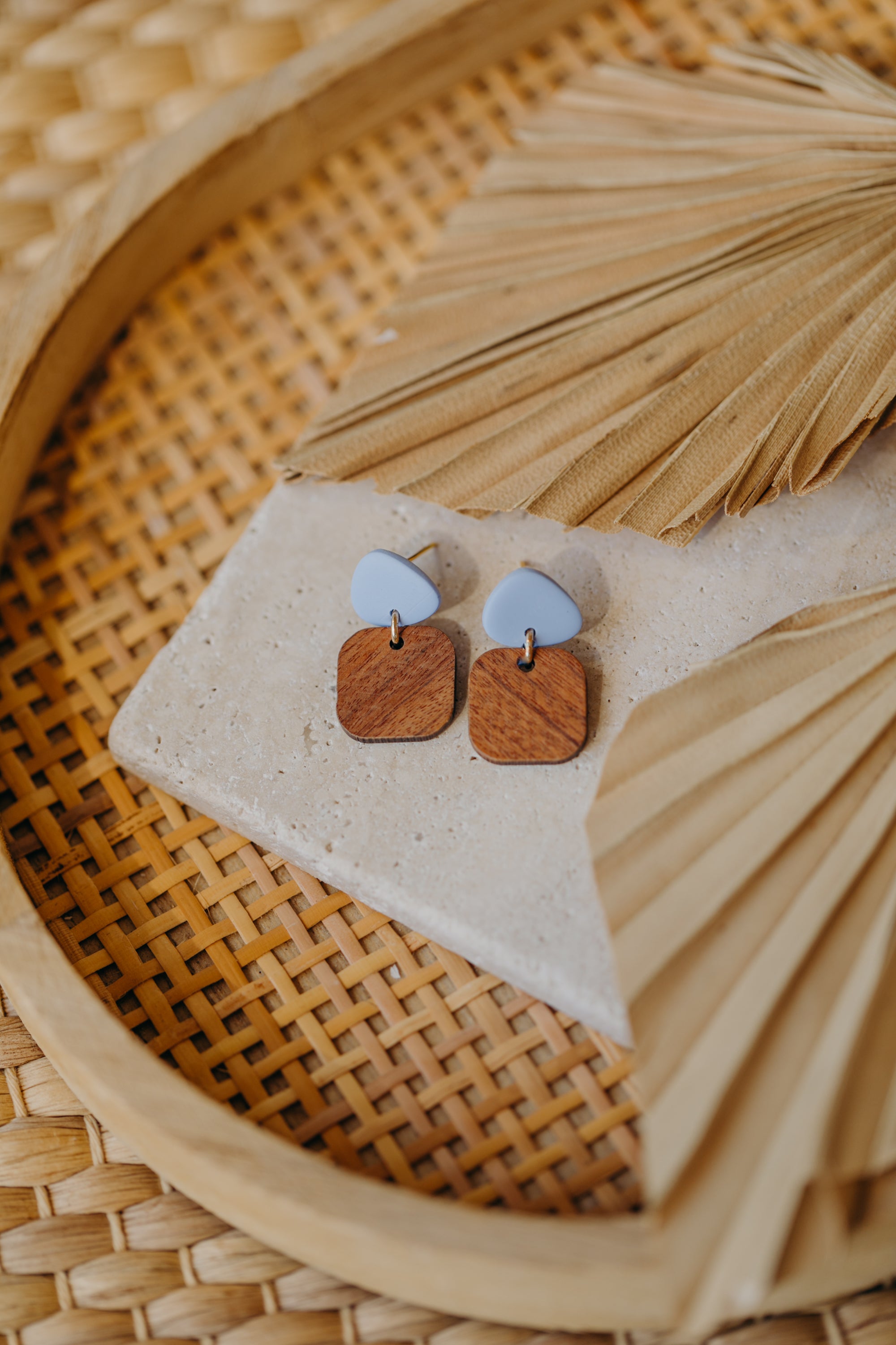 triangular polymer clay earrings in pastel blue with rectangular wooden pendant