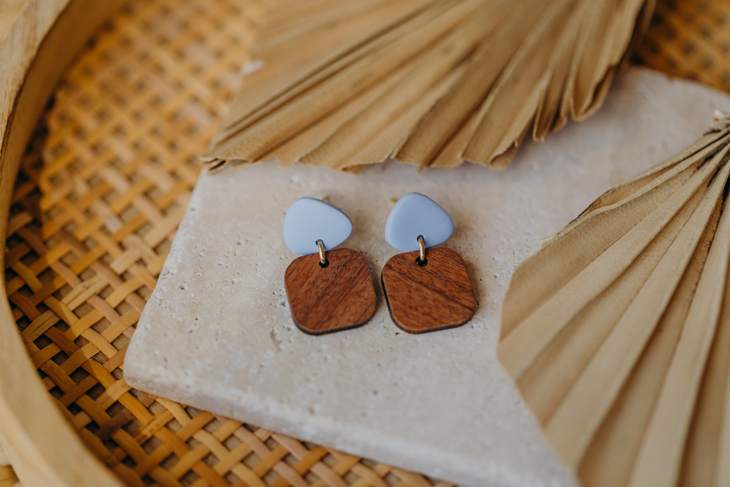 triangular polymer clay earrings in pastel blue with rectangular wooden pendant