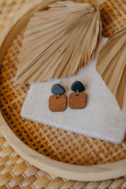 triangular polymer clay earrings in black with rectangular wooden pendant