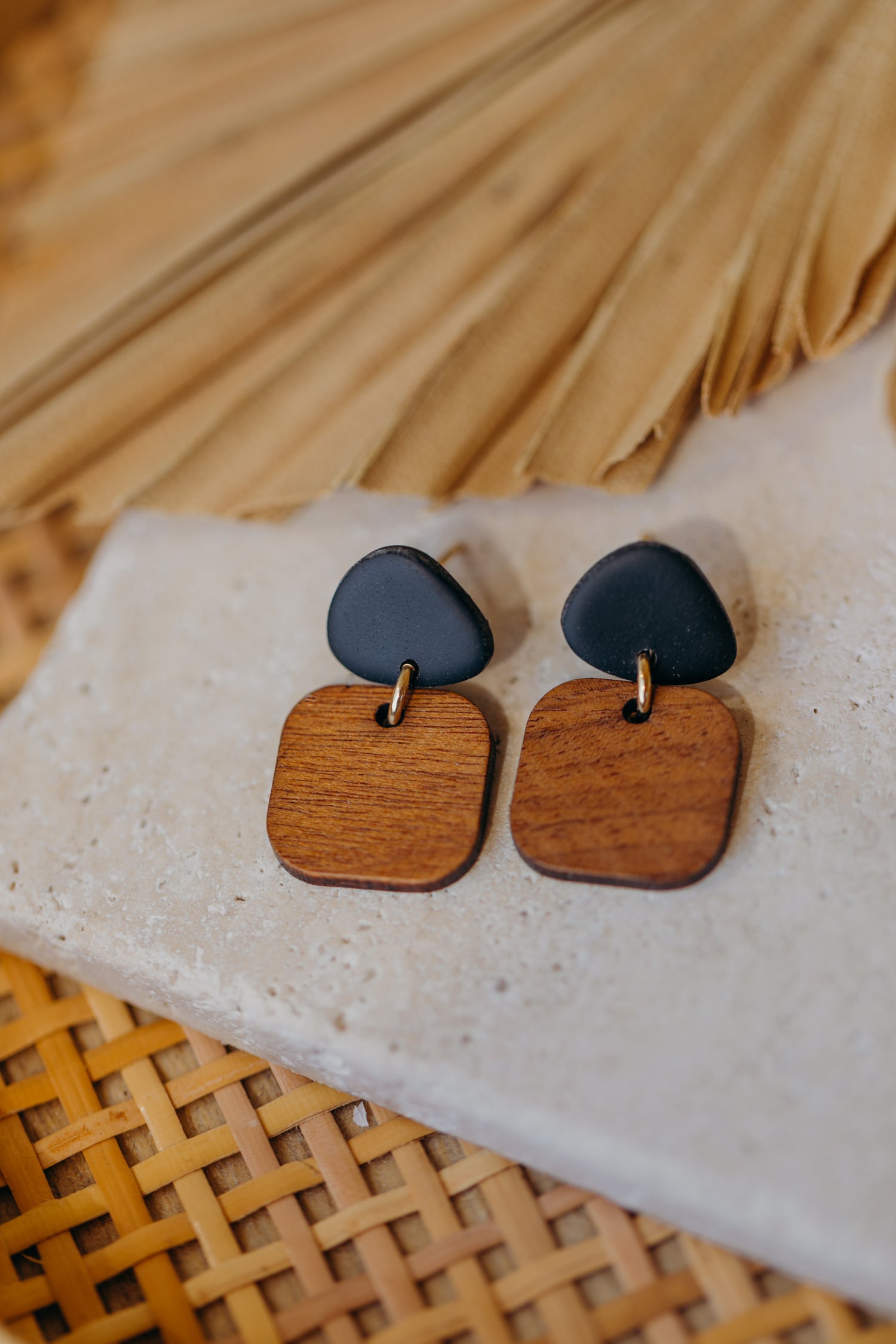 triangular polymer clay earrings in black with rectangular wooden pendant