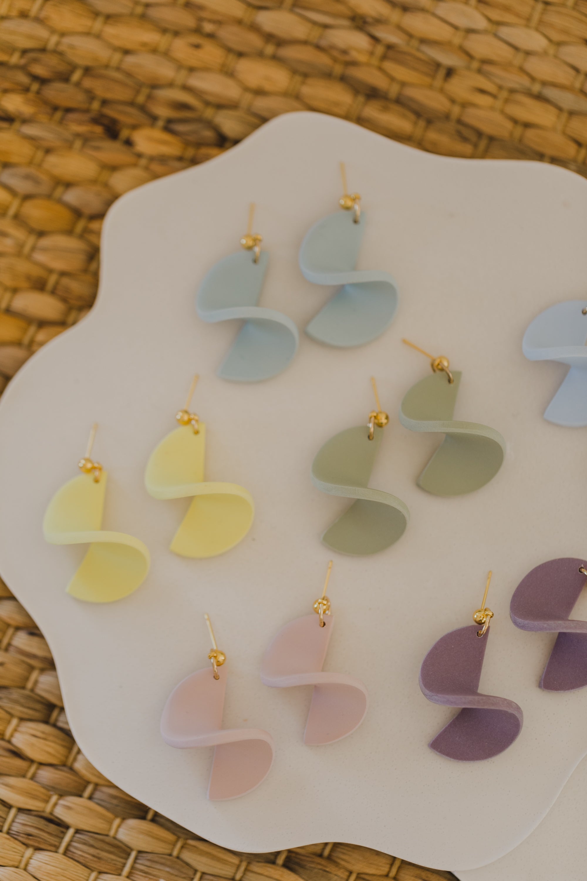 twisted earrings made of polymer clay in pastel colors