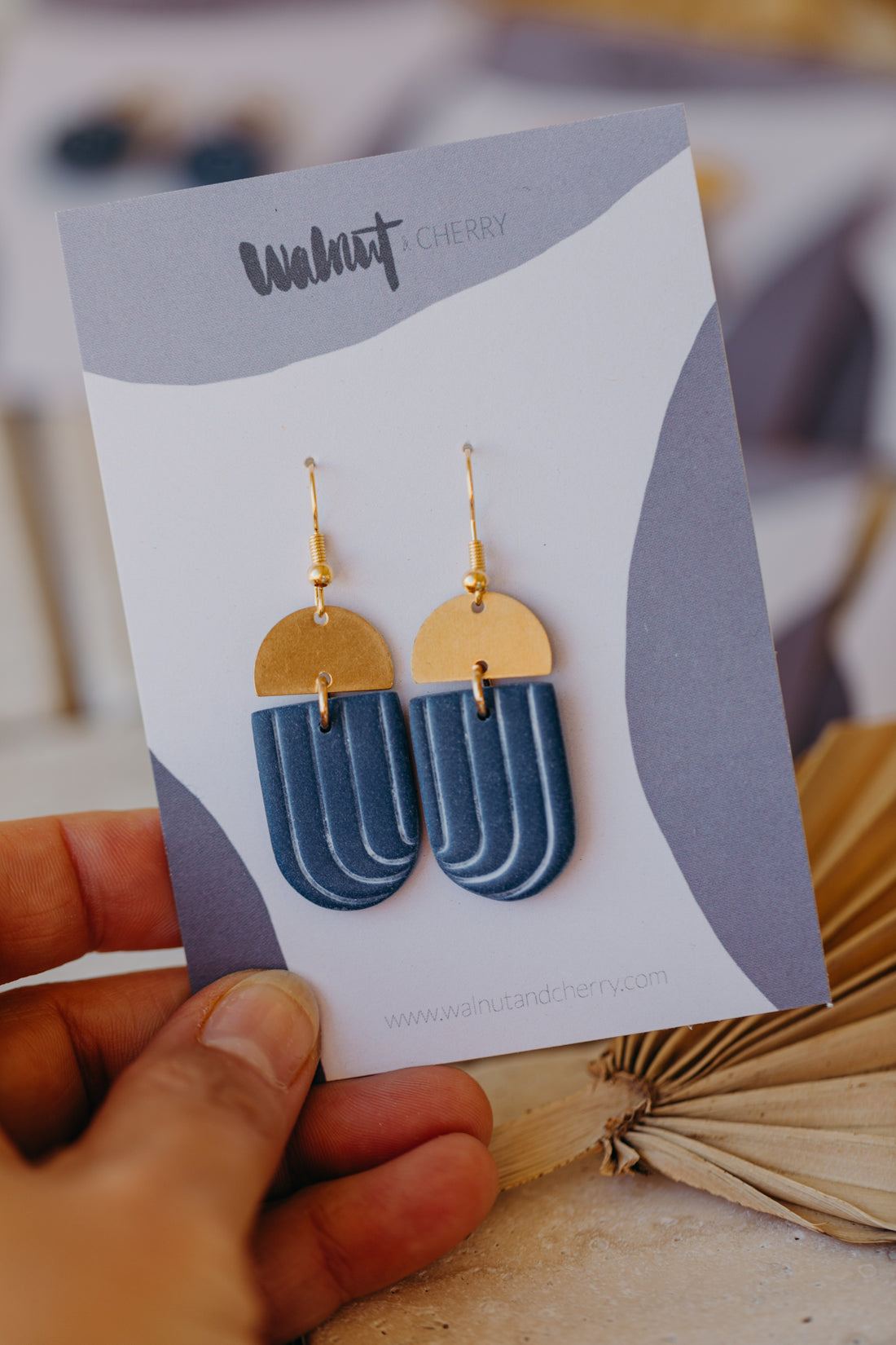 Dark blue polymer clay earrings with white lines