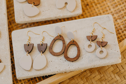 triangular polymer clay earrings in eucalyptus green with rectangular wooden pendant