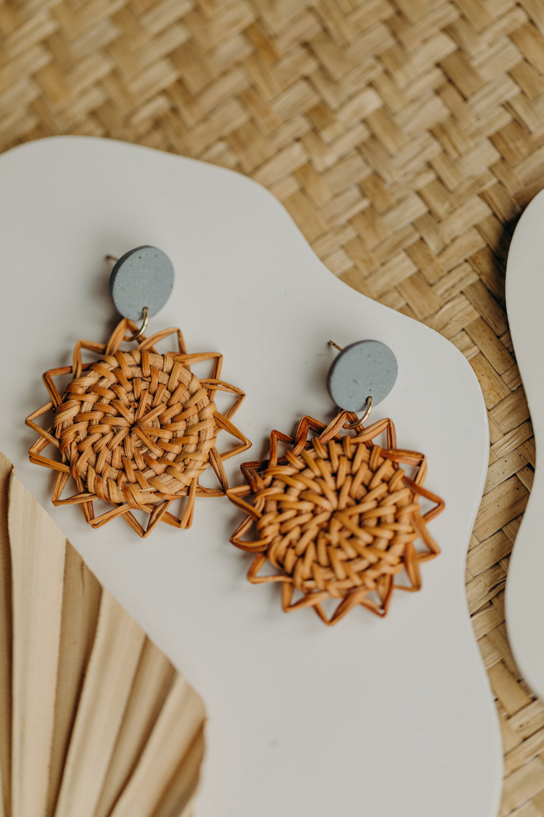 round polymer clay earrings in black with rattan pendant sun