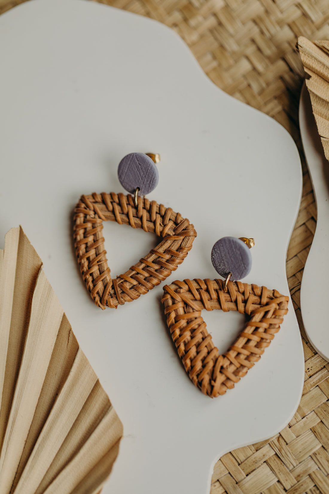 square polymer clay earrings in the color light purple with rattan pendant triangle