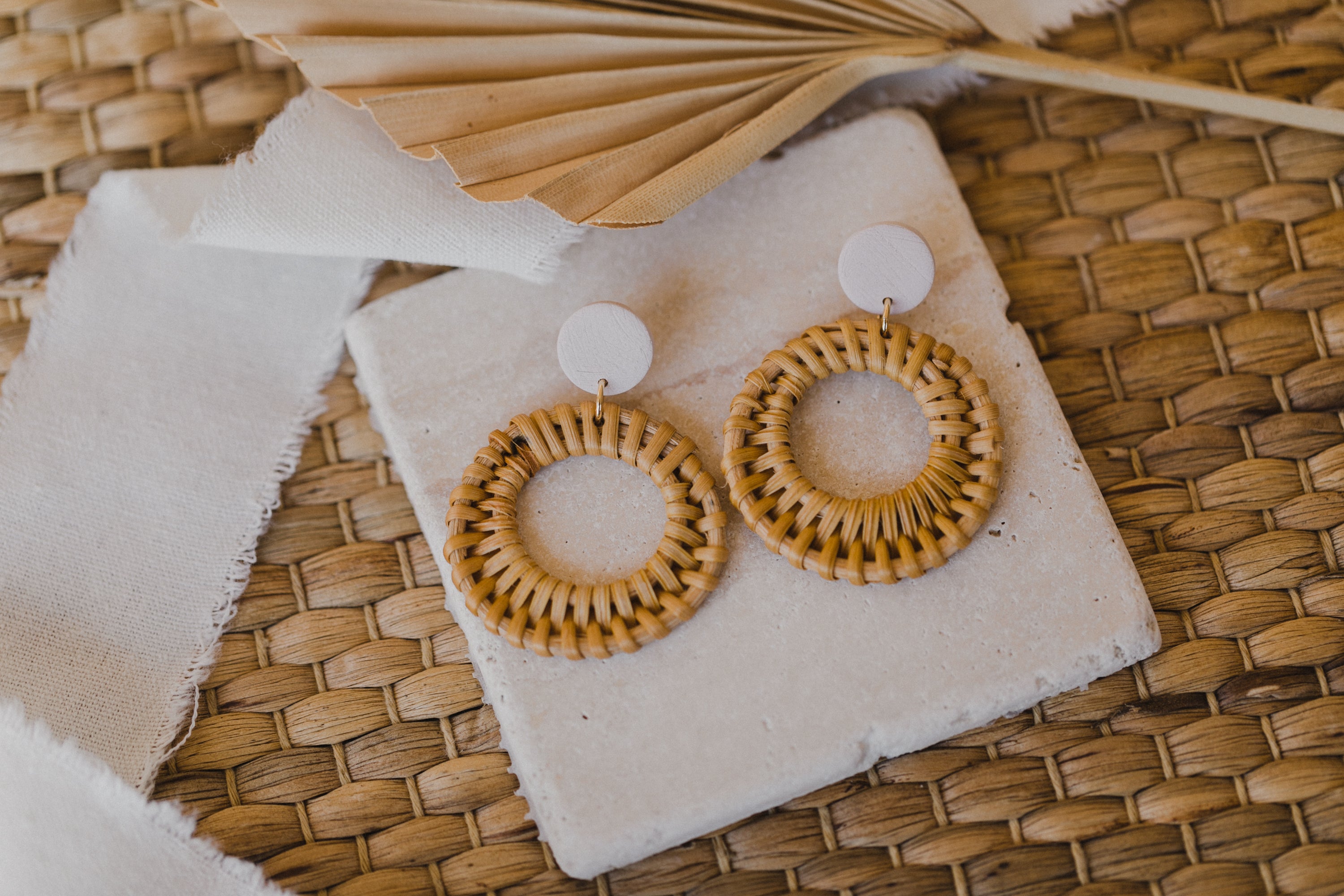 round polymer clay earrings in the color light pink with rattan pendant circle