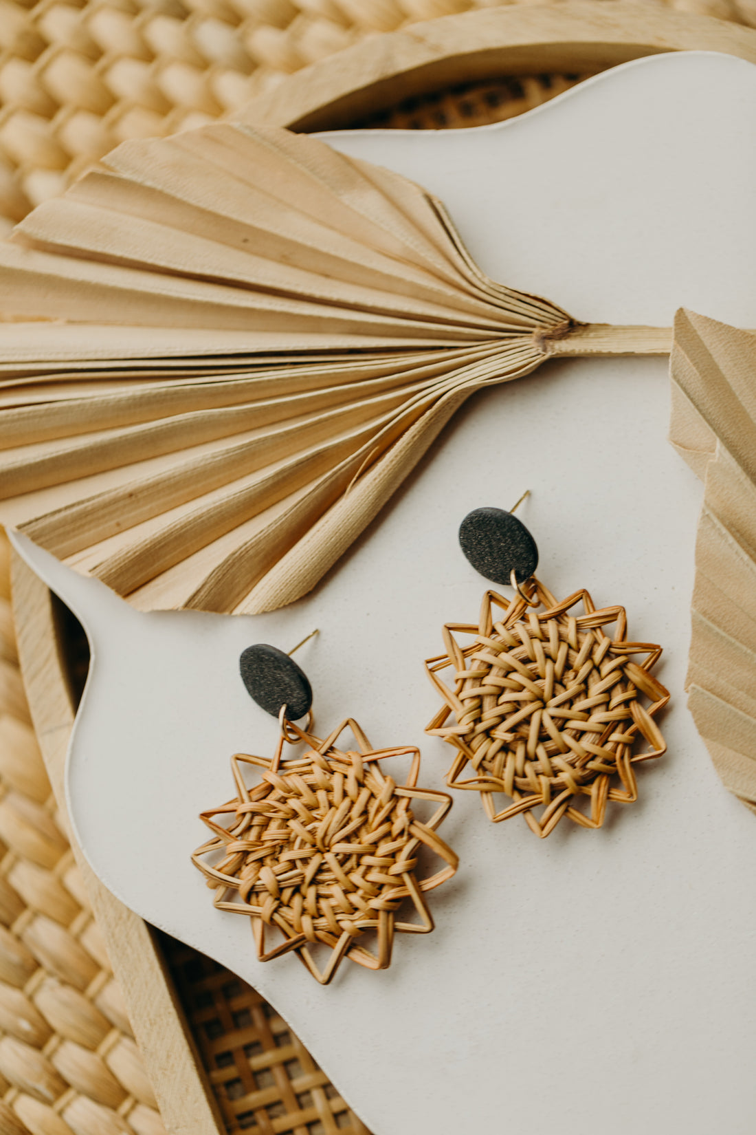 round polymer clay earrings in black with rattan pendant sun