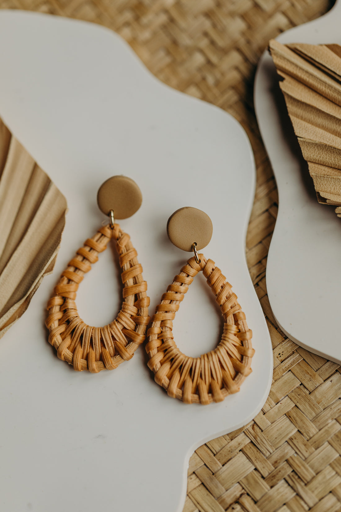 dark blue polymer clay earrings with rattan pendant drops