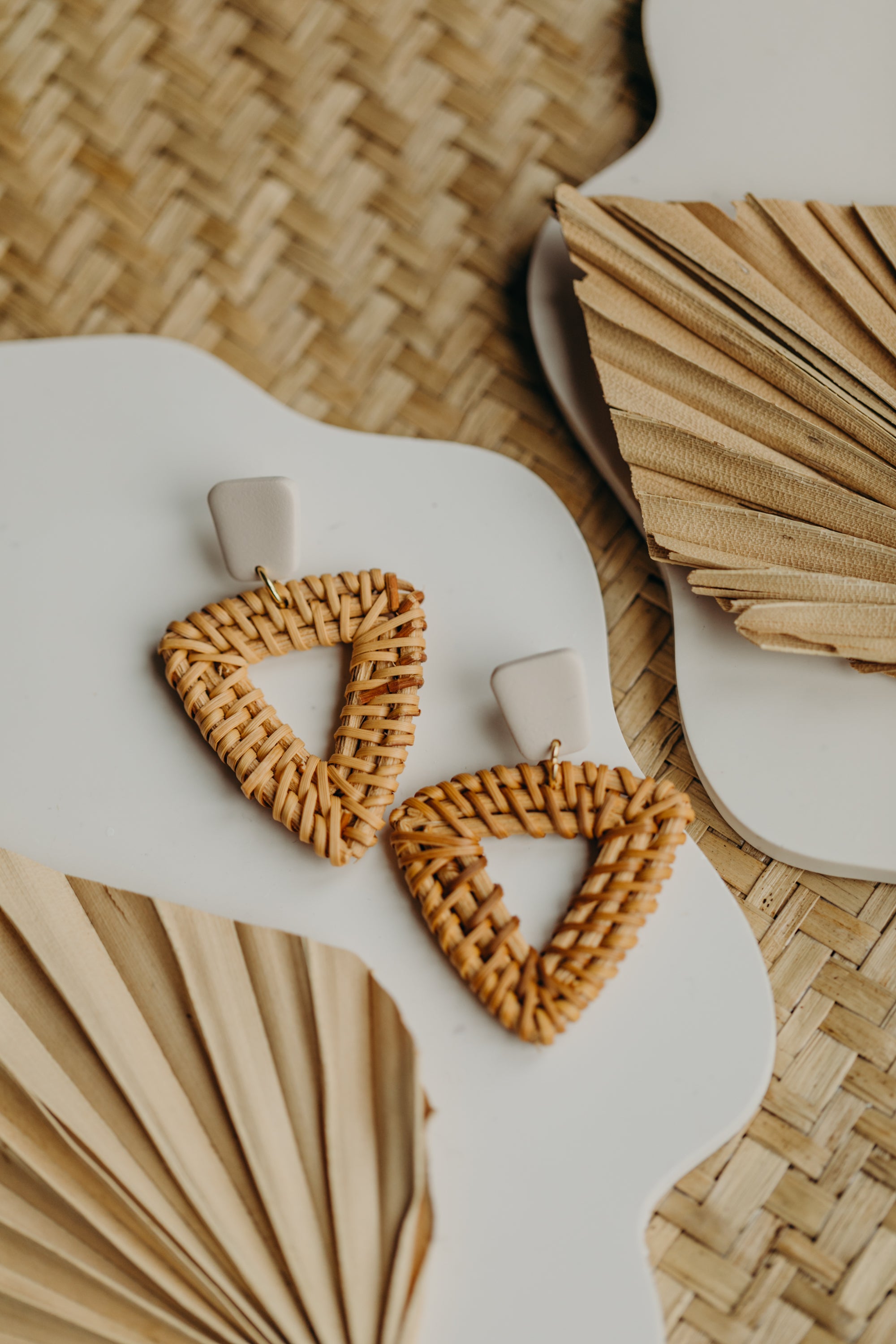 triangular polymer clay earrings in the color Barolo with rattan pendant triangle