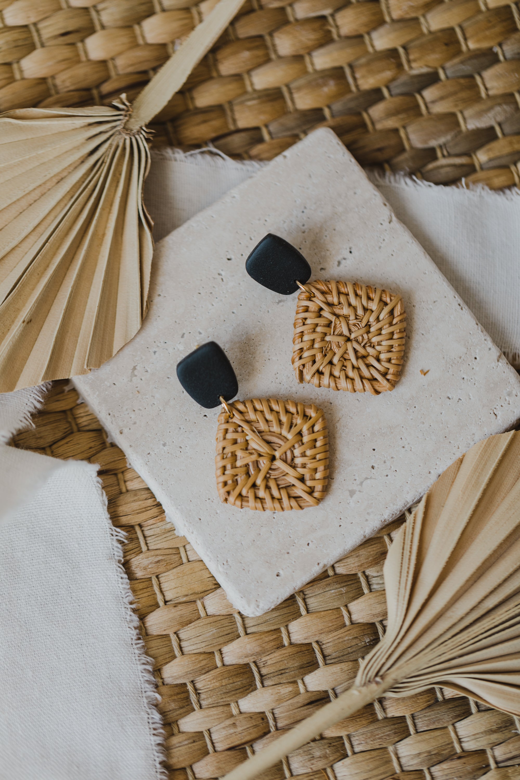 square polymer clay earrings in black with rattan pendant square