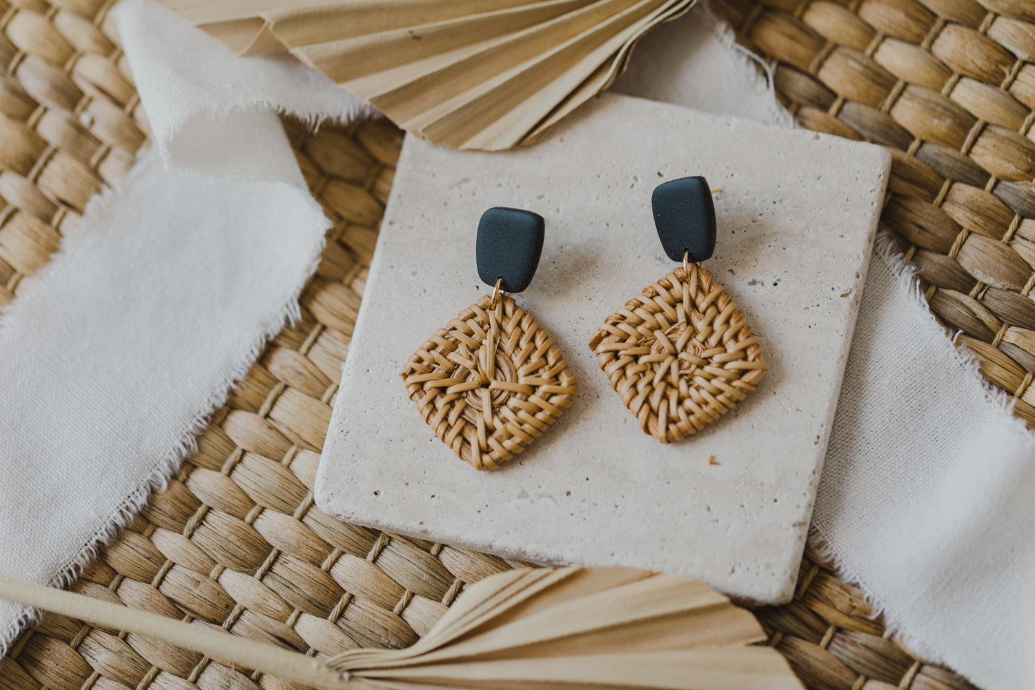 square polymer clay earrings in black with rattan pendant square