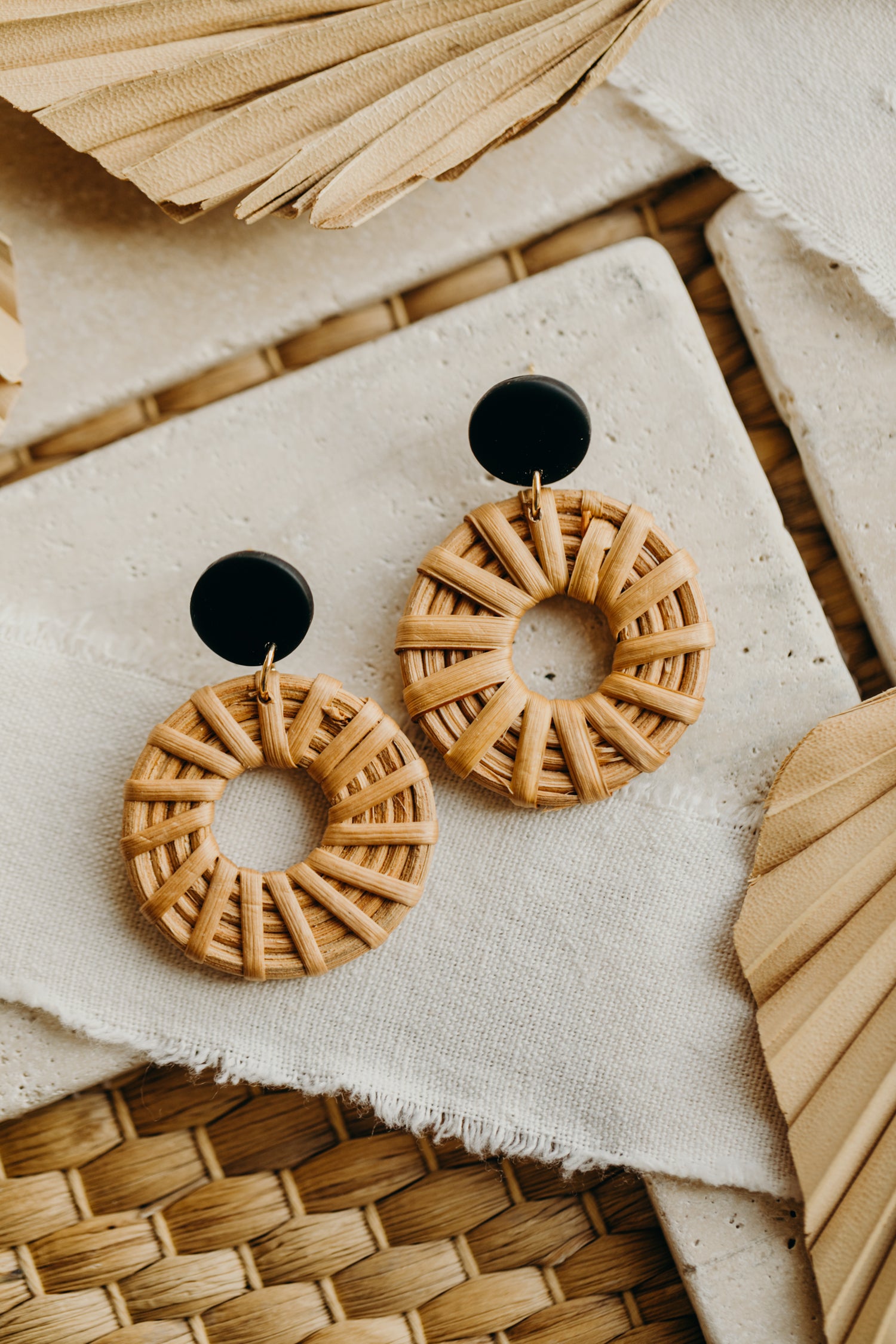 round polymer clay earrings in black with rattan pendant circle