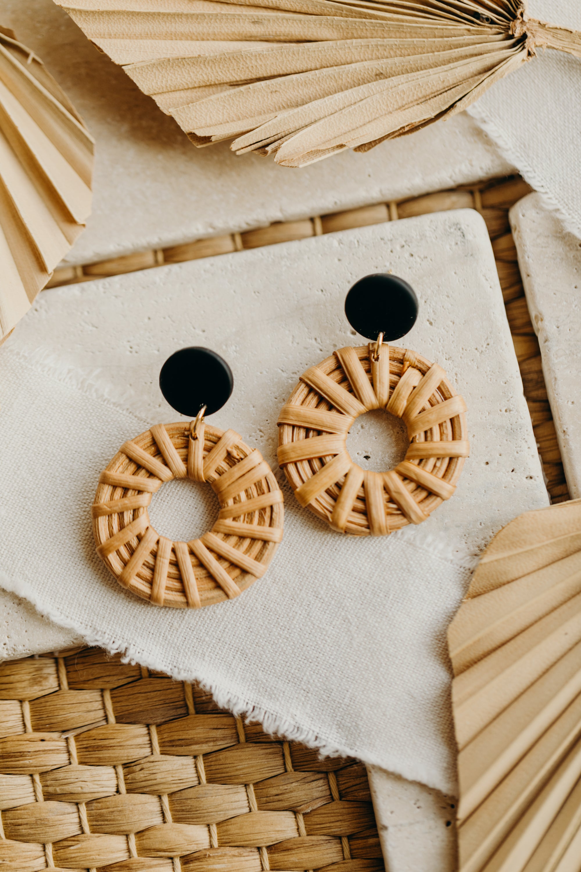 round polymer clay earrings in black with rattan pendant circle