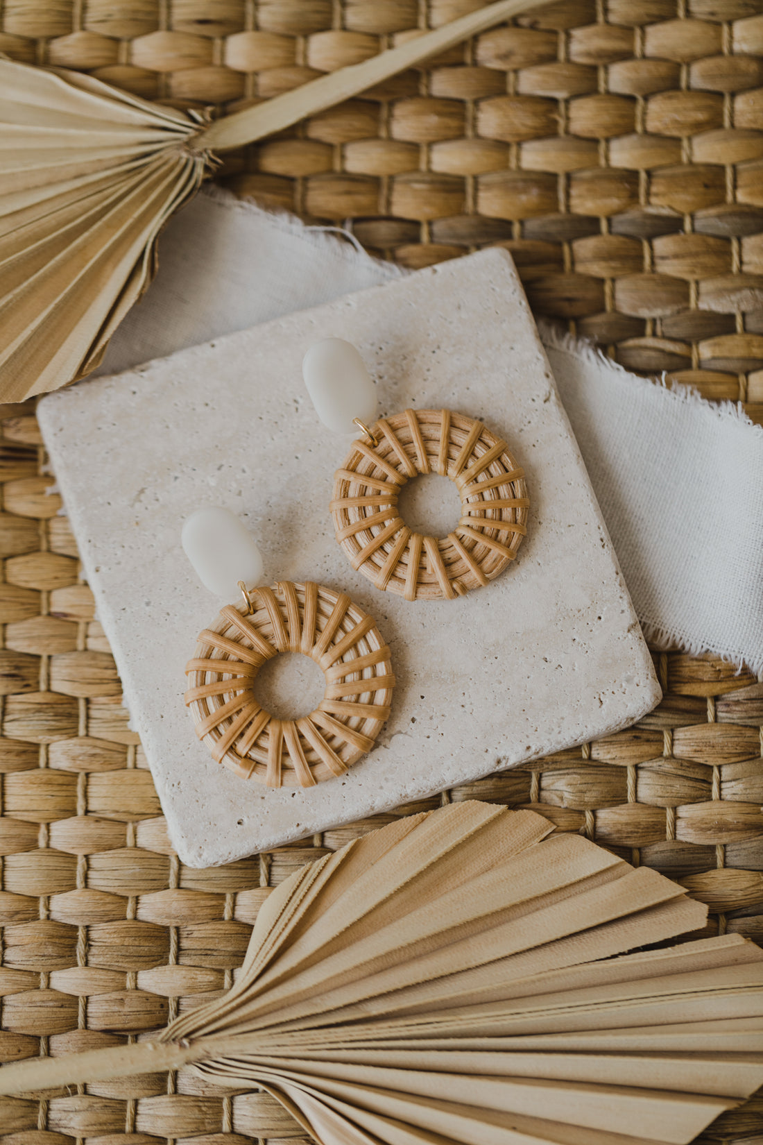 oval polymer clay earrings in the color cream transparent with rattan pendant circle