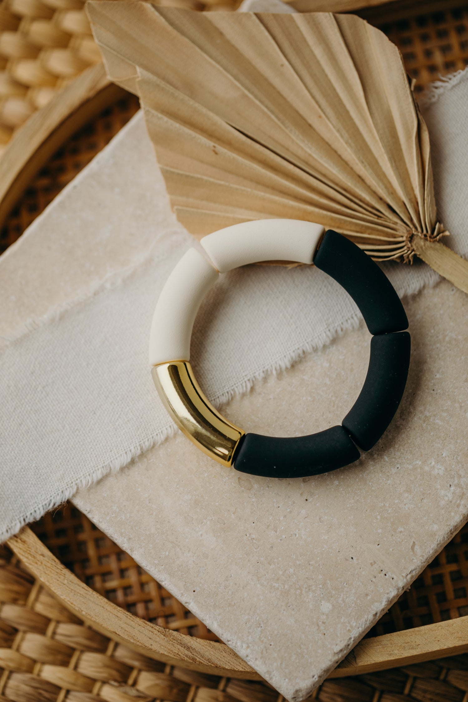 Pearl bracelet with tube pearls in gold, white, and black